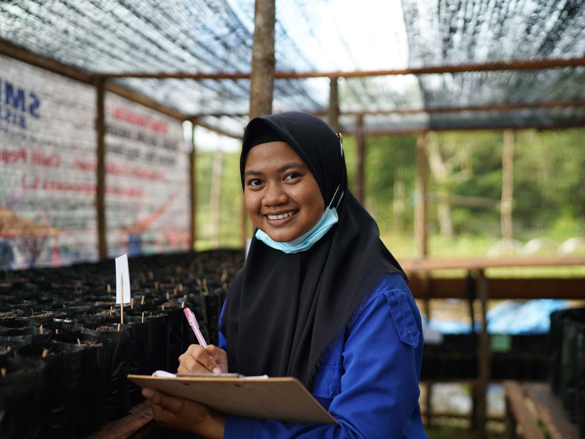 An agroforestry worker doing her job while working at the Katingan Peatlands Project.